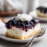 Easy Blueberry Delight Recipe – Creamy, Fruity & No Bake! 9 Layered blueberry delight dessert. creamy filling, blueberry topping, and whipped cream.