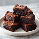 Easy Fudgy Espresso Brownie Bites | Bite-Sized Chocolate & Coffee Bliss 7 Fudgy espresso brownie bites topped with coffee sprinkles on a plate.