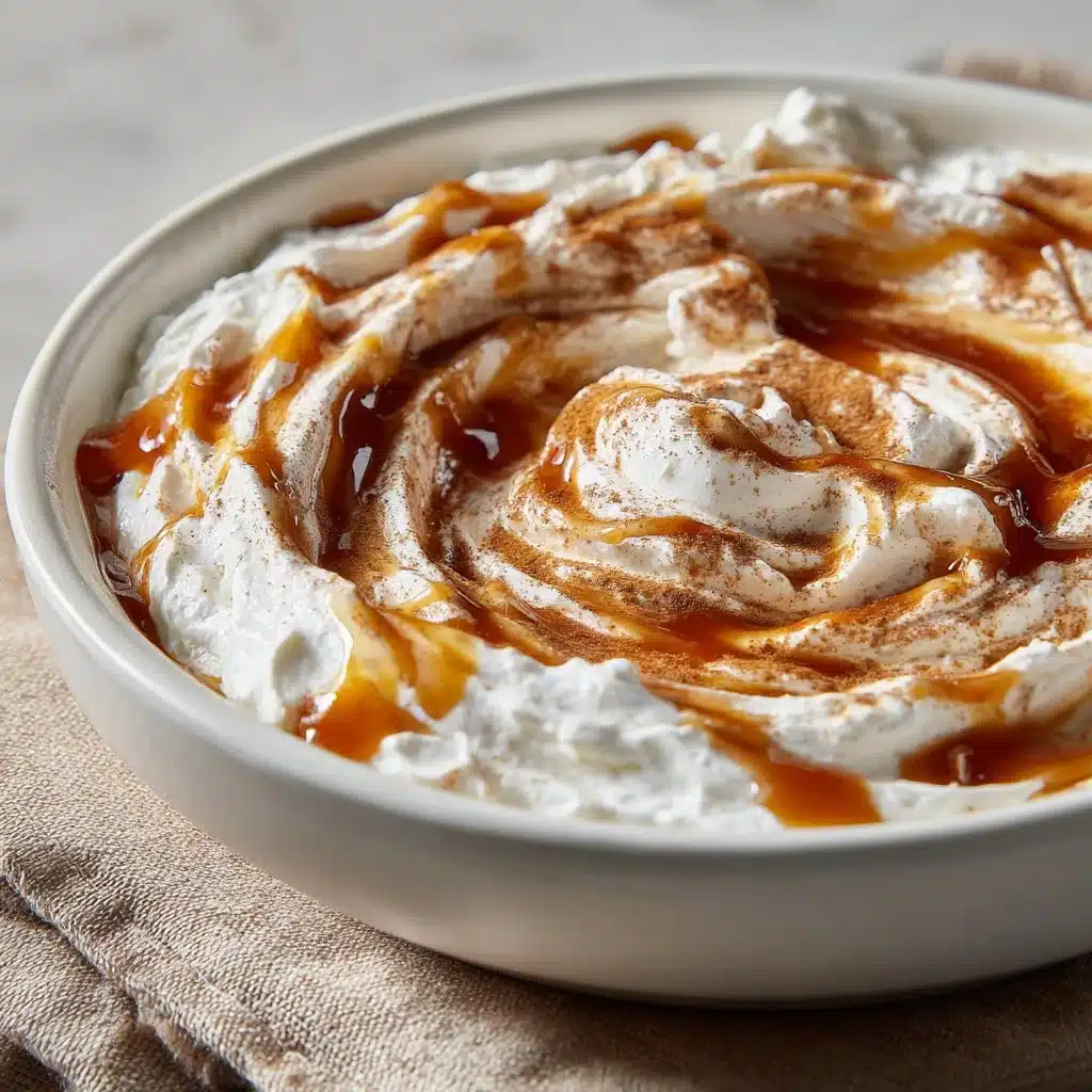 Delicious Cinnamon Roll Dip – Creamy, Sweet & Perfect for Sharing 5 Bowl of creamy and sweet cinnamon roll dip with a serving spoon