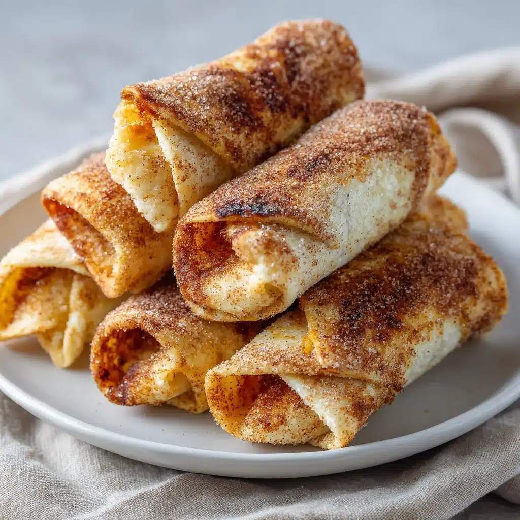 12-Minute Air Fryer Cinnamon Sugar Tortilla Rolls 3 Cinnamon sugar tortilla rolls served on a plate, ready to enjoy.