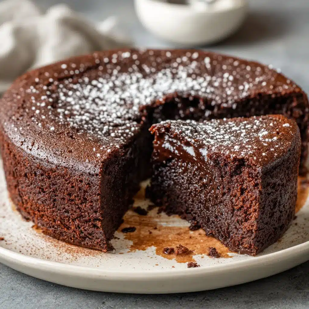 Decadent Flourless Chocolate Cake topped with chocolate ganache and berries.