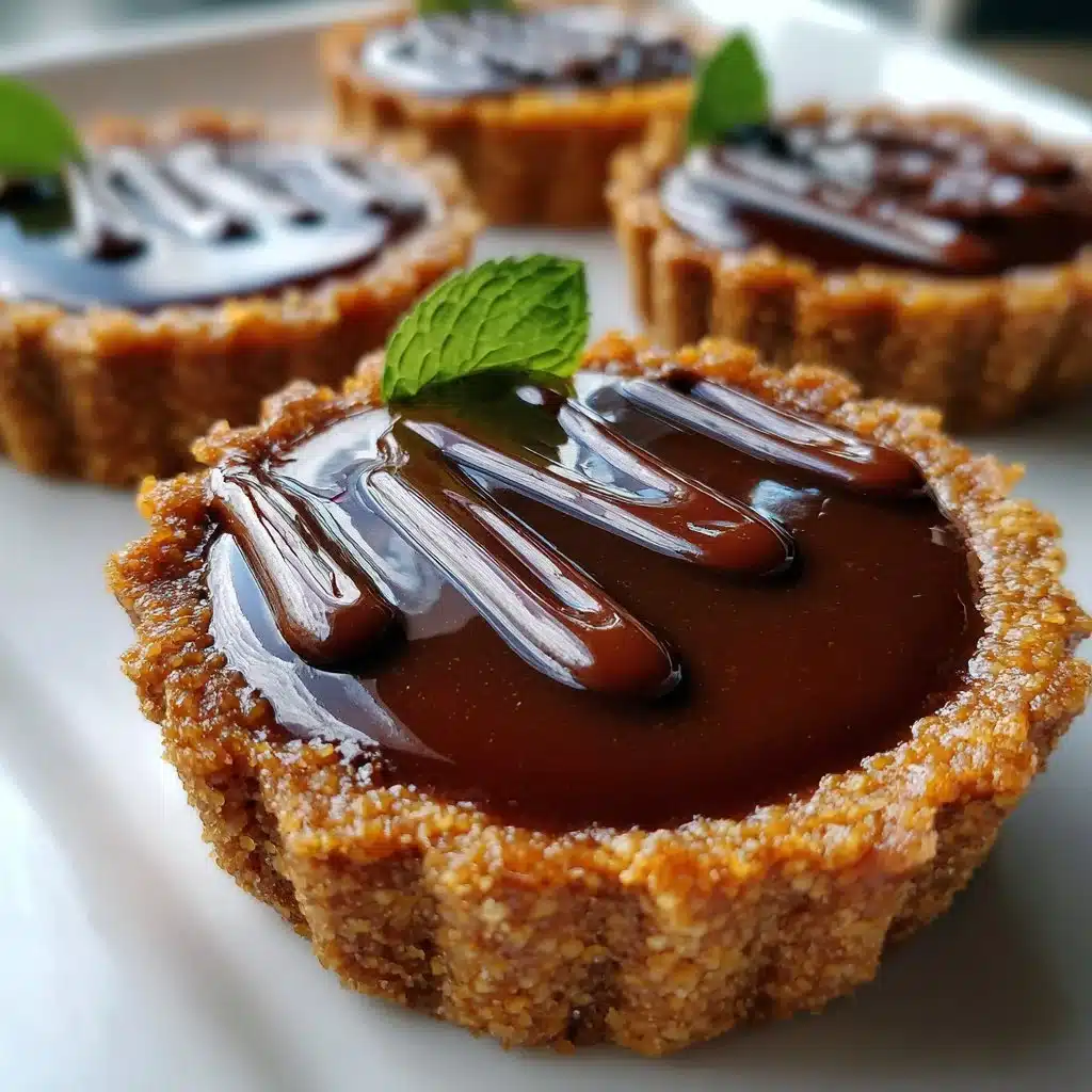 Delicious Vanilla Caramel Chocolate Tartlets garnished with chocolate and caramel drizzle