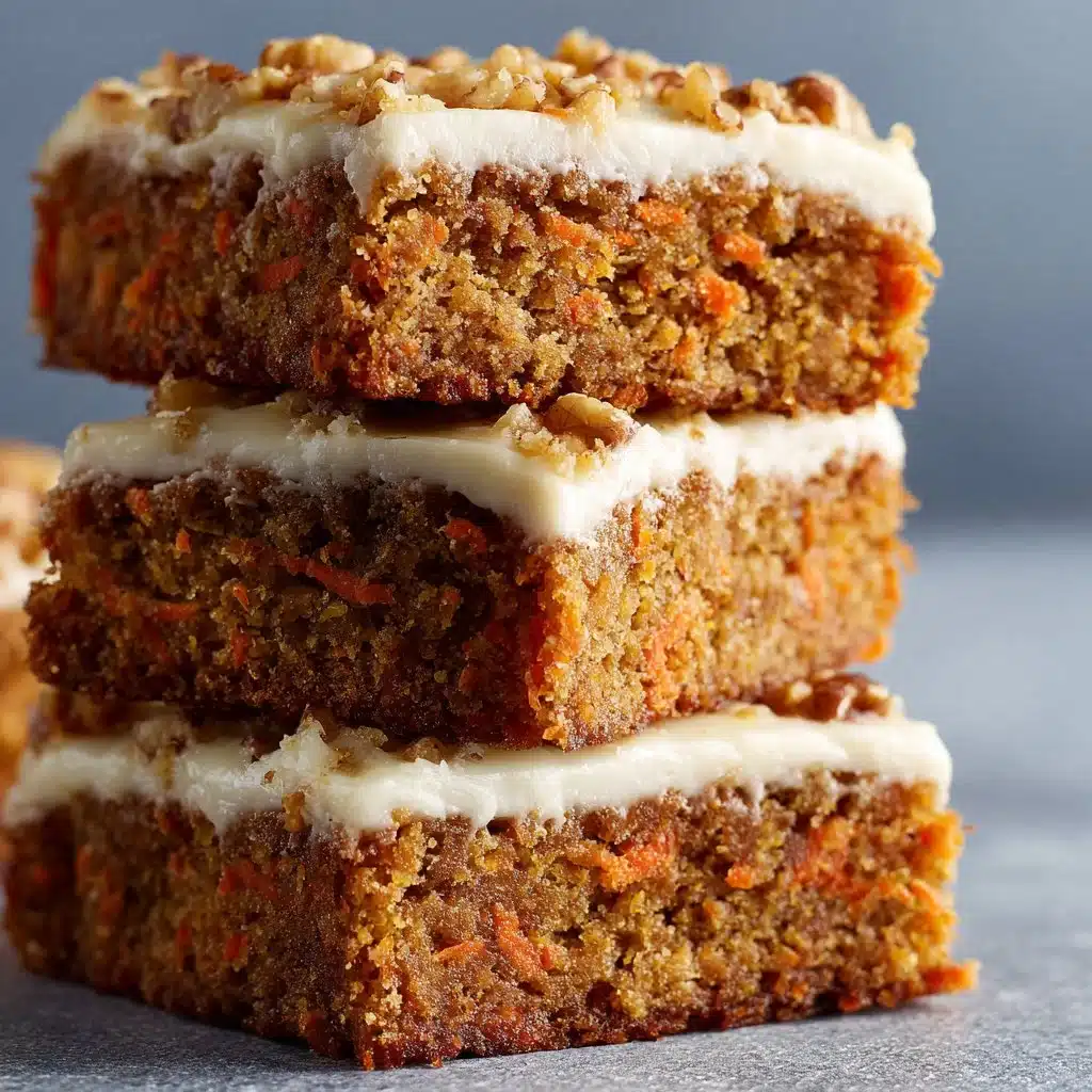 Delicious carrot cake bars topped with cream cheese frosting on a wooden plate.